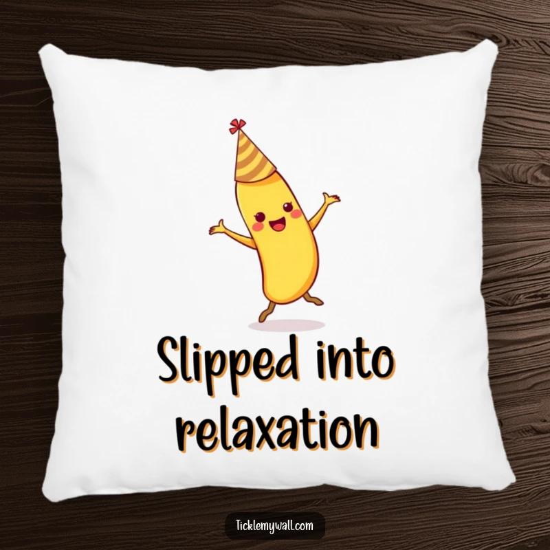 Funny dancing banana wearing a party hat slipping on its own peel on a soft decorative pillow.