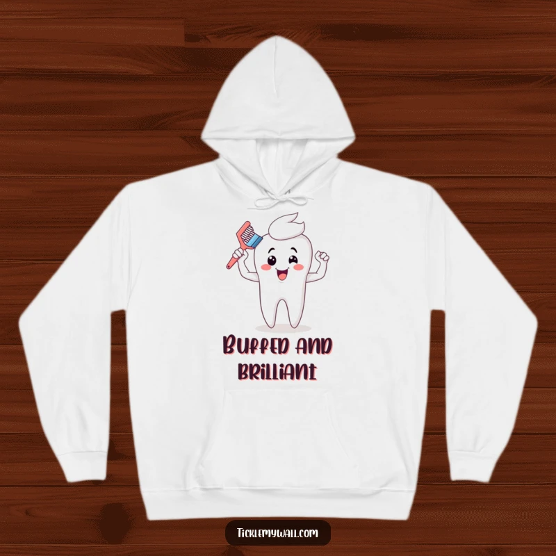 Funny toothbrush hoodie showcasing cartoon muscles after dominating a giant tooth, offering warmth and a humorous dental statement.