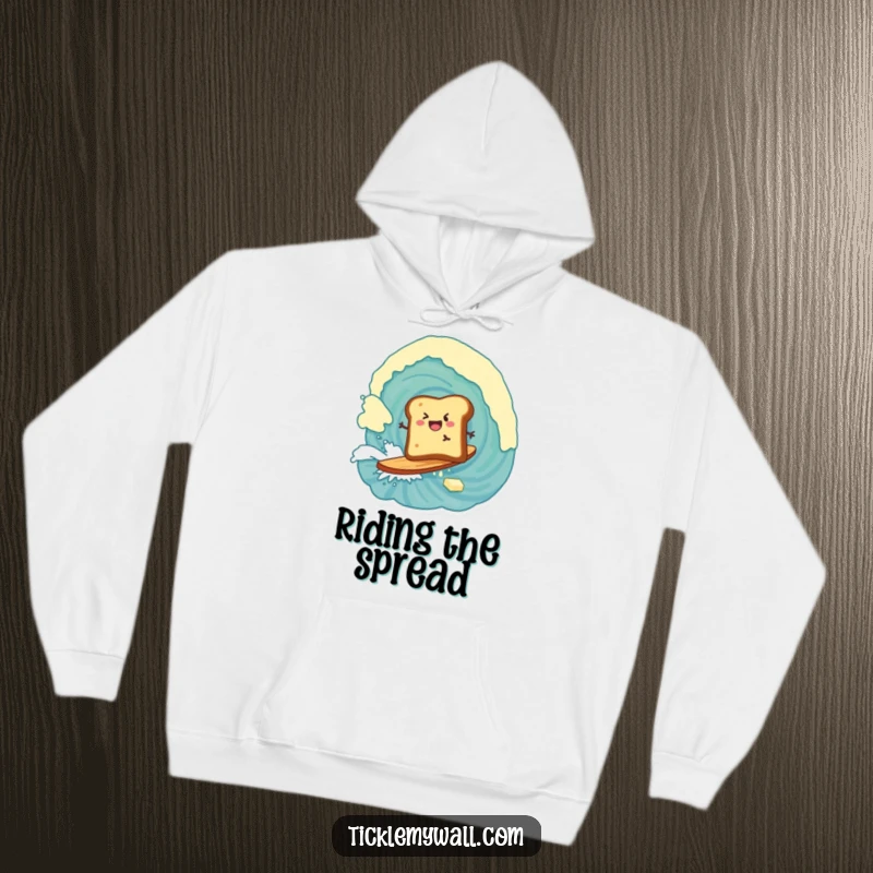 Funny hoodie illustrating a piece of toast adventurously surfing a large wave of butter, a breakfast delight.
